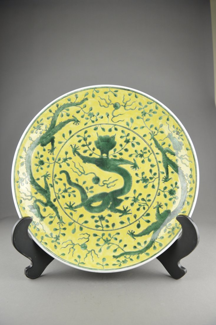 Chinese Minguo Dragon Charger Kangxi Kiln MK: Chinese Minguo yellow and green dragon charger; the centre featuring a writhing five-toed dragon with a flaming pearl; the cavetto featuring two striding dragons chasing a flaming pearl, supported on