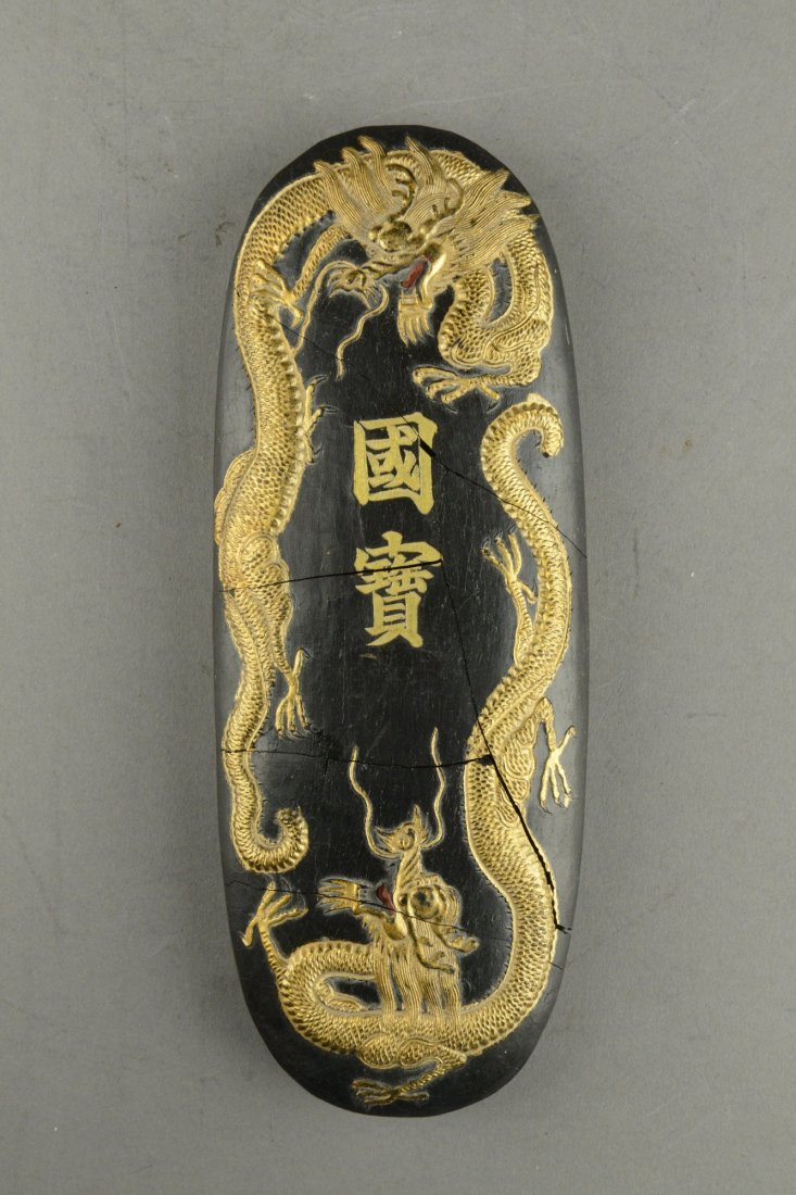 Chinese Ink Stone Marked Ming Xuande: Of oval pebble shaped, the ink stone is carved with golden dragons on front and bats at the back. Marked Ming Xuande. Broken and restored. H: 20 cm, W: 8 cm, 388 grams.