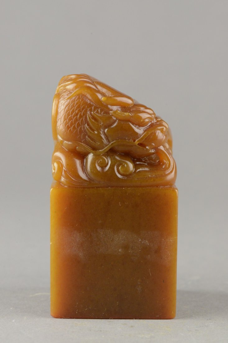 Chinese Carved Tianhuang Stone Seal: Of apricot tone, the rectangular Tianhuang stone seal is surmounted with a dragon in sea waves. Bottom carved Liang Hu San Zhu Wan He. H: 8.5 cm, W: 4.5 cm, 421 grams.