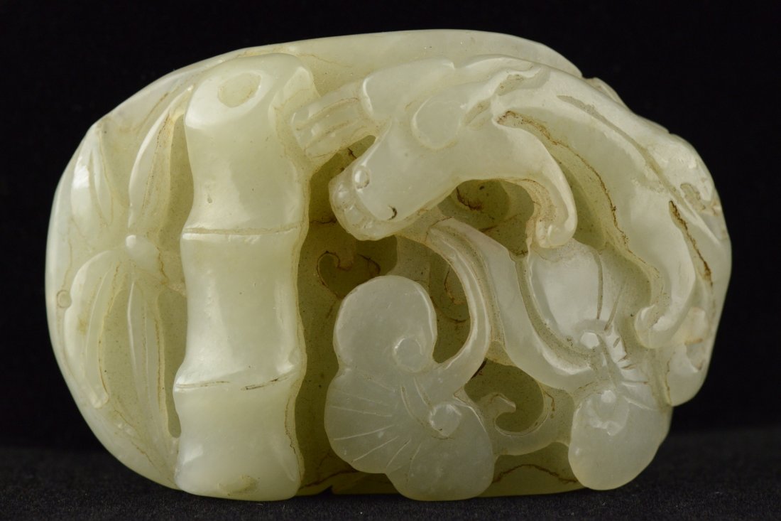 Chinese Celadon Jade Carved Chilong and Bamboo: Of celadon tone, the jade is carved with auspicious chilong, bats and bamboo. H: 7 cm, W: 5 cm, 139 grams.
