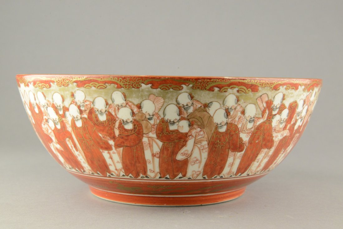 Japanese Kutani Bowl 19thC Meiji Period Nippon: A Japanese gilded hand painted porcelain bowl, painted continuous scenes of man on the exterior and birds and flowers on the interior. Bottom marked Kaga No Kuni Kutani. H: 9 cm, D: 23 cm, 966 grams.