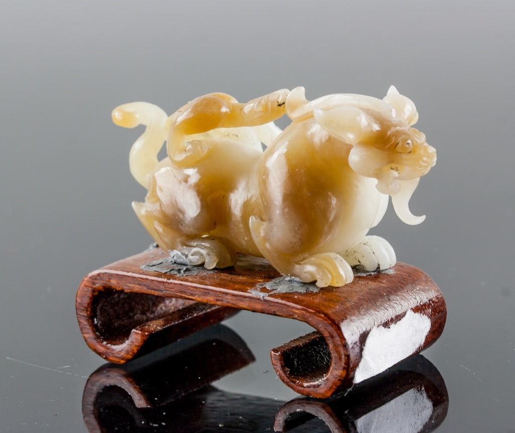 Chinese Fine Jade Carved Chilong w/ Stand: Chinese fine carved Chilong. Featuring Chilong with a baby on back. Wwhite tone with russet skin. Custom wood stand included. H: 3 cm, W: 6 cm, 38 grams w/ standCountry of Origin: Asia*Information on