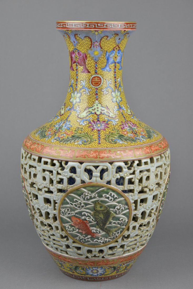 Chinese Famille Rose Reticulated Vase Qianlong: Chinese Famille Rose enameled porcelain vase, reticulated design, with an inset medallion depicting auspicious waves in front of crashing waves, above and below the geometric dragon band features fore