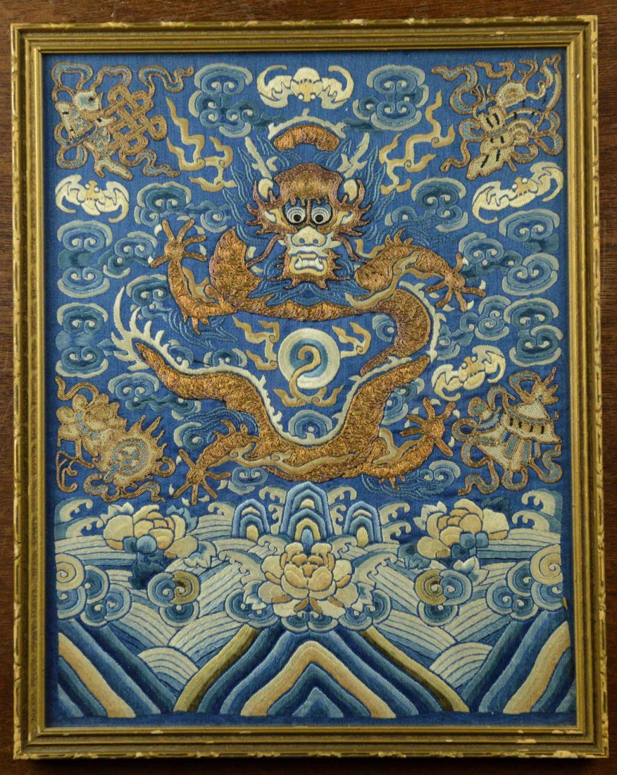 Chinese Embroidery Dragon Guan Rank Badge: Chinese embroidery guan rank badge, featuring dragon in the middle with a framing pearl amidst clouds, bats, lotus and sea waves. Framed in gold colour frame. 28 cm x 29 cm.