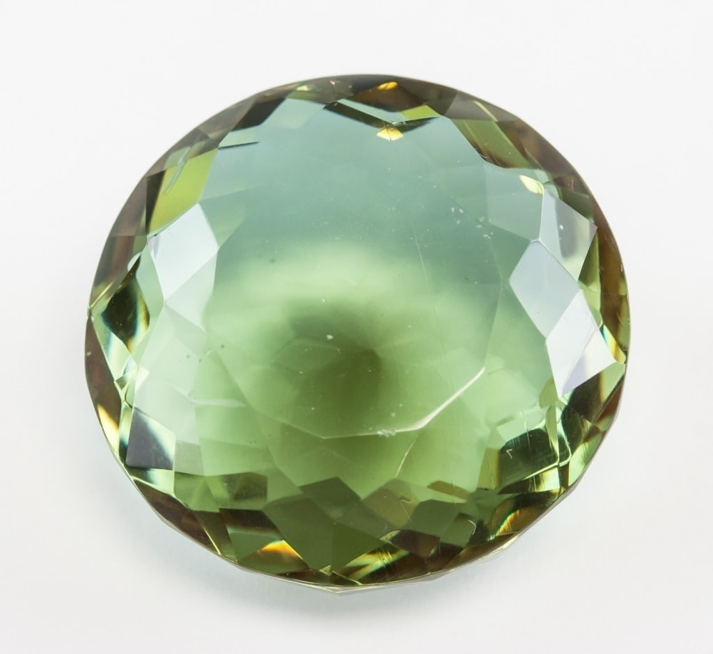 95.00ct Round Cut Brown to Green Alexandrite GGL: One (1) 95.00 ct round cut brown to green Alexandrite. Origin: Brazil. Accompanied with a GGL certificate. 29.76 x 29.92 x 15.86 mm Country of Origin: Brazil *Information on Tariffs on Art and Antique