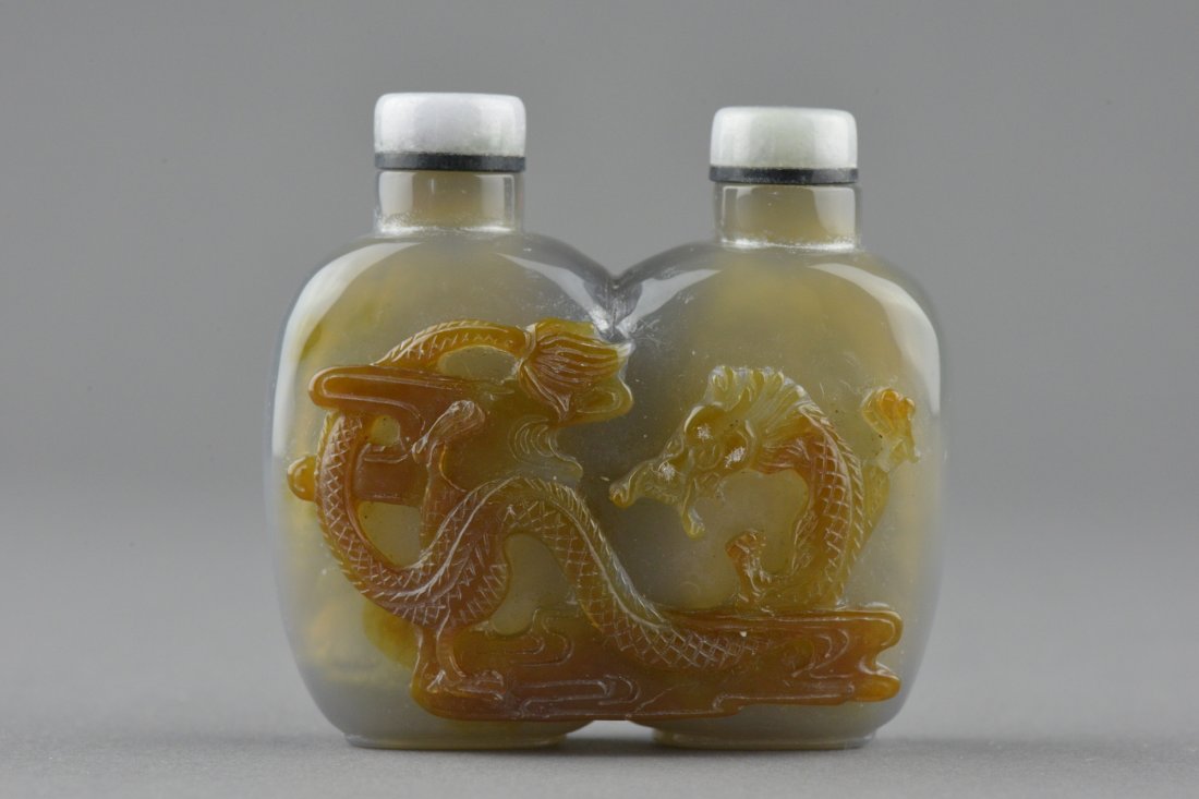 Chinese Carved Agate Twin Snuff Bottle with Cap: Chinese carved agate twin snuff bottle with cap; featuring dragon on cloud; the stone of smoky gray and light apricot tone ; Provenance: T. Ng Collection Toronto