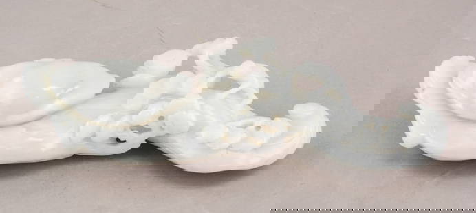 Chinese Hetian White Jade Carved Ruyi Scepter: The scepter is made of Hetian white jade and is intricately carved with elaborate designs that are symmetrically arranged. The jade has a smooth, polished surface with an alluring luster. 26 x 8 cm, 1