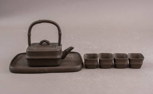 Chinese Yixing Clay Carved Zisha Tea set: Chinese Yixing clay Zisha tea set comprising a rectangular teapot with curved handle and spout, accompanied by four matching square-form teacups and a rectangular tray, all crafted from dark brown cla
