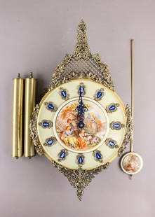 Rare West Germany Schmeckenbecher Brass Clock: Rare West Germany Schmeckenbecher Brass Clock. Ornate mechanical wall clock featuring a gilt brass frame with filigree detailing, circular dial with cobalt blue Roman numerals, and shaped brass hands.