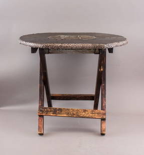 Antique African Wood Carved Folding Table: Antique African Wood Carved Folding Table. Handcrafted from dark hardwood with a folding tripod base and circular top featuring detailed geometric and symbolic carvings. The table folds compactly, wit