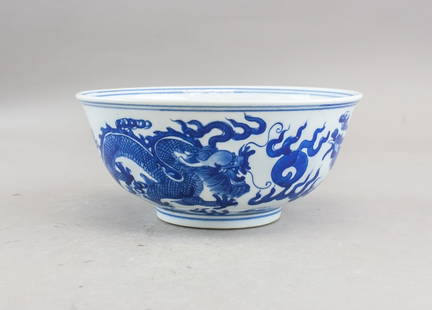 Chinese Blue & White Porcelain Bowl Kangxi Mark: Chinese Blue & White Porcelain Bowl with Kangxi Mark, featuring a flared rim and slightly raised foot. The exterior is decorated in underglaze blue with a sinuous dragon amid swirling clouds, rendered