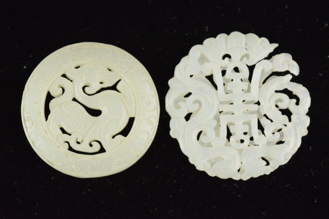 Pair Of White Jade Medallion Carved Shao Symbols: Fine pair of Chinese circular jade pendant of even white tone. First featuring an archaic dragon within circular scroll; Second featuring Shao symbol with open works Fu bats and leafy sprays. D: 5 cm,