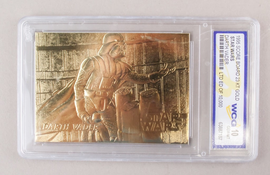 1995 Score Board 23kt Gold Darth Vader WCG 10: 1995 Score Board 23kt gold Star Wars Darth Vader card, featuring an embossed image of Darth Vader on the front, with the "Star Wars" logo and "Darth Vader" text prominently displayed. The card is grad