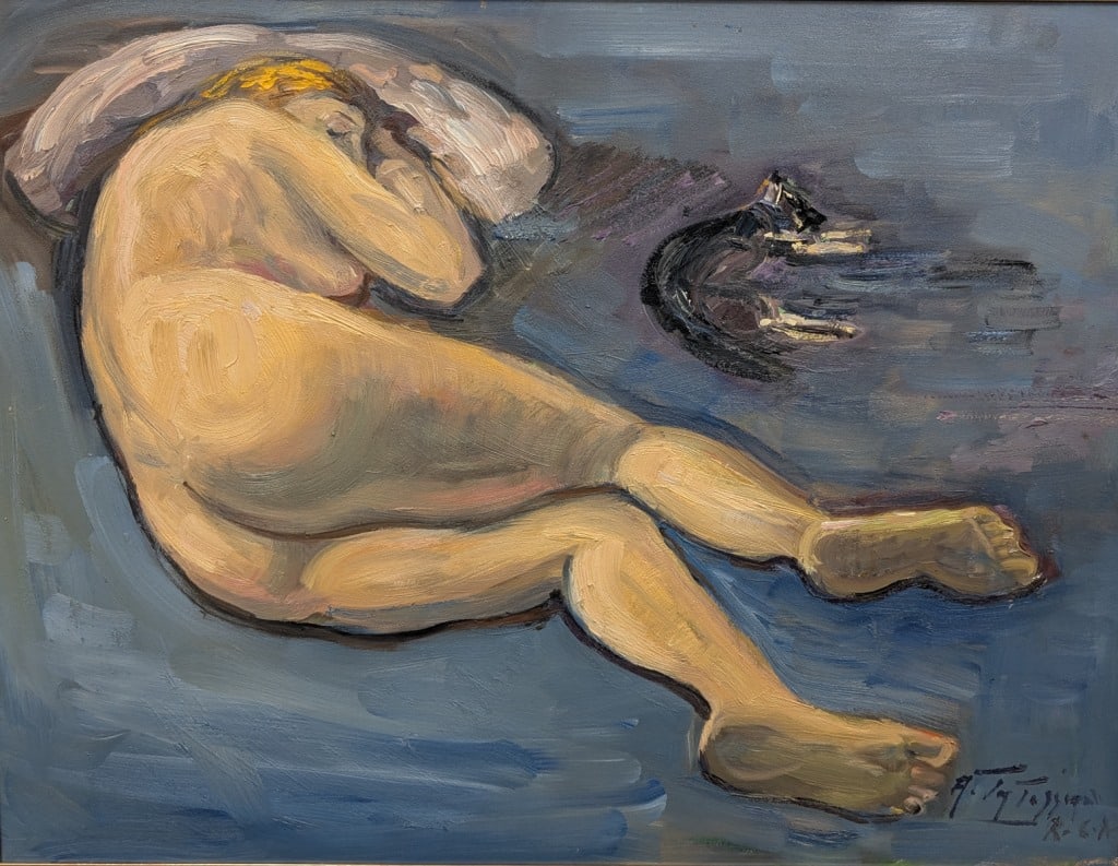 Canadian Large OOC Signed Armand Tatossian '2002: Oil on canvas, framed. Attributed to Armand Tatossian (1948 - 2012). This work presents a reclining nude female figure resting on a blue surface, her head supported by a pillow, with a black cat posit