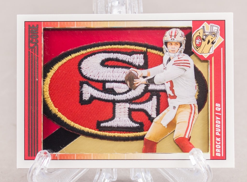 2023 Panini Brock Purdy Jersey Patch Card: 2023 Panini Zenith Football Brock Purdy jersey patch card, No. 88, featuring a large multicolor jersey swatch (not verified) and action image of the San Francisco 49ers quarterback. Reverse includes p