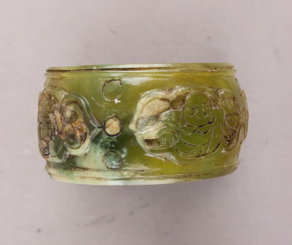 Chinese Antique Green Jade Carved Bracelet: Chinese antique green jade bracelet, carved in a continuous circular form with even thickness and a smooth, polished finish. The jade displays a translucent green coloration with natural mottling and