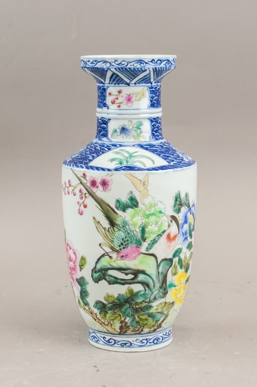 Chinese Famille Rose Porcelain Vase Daoguang Mark: Chinese Famille Rose porcelain vase of baluster form with flaring neck and everted rim, decorated in bright enamels with flowering branches, butterflies, and auspicious motifs on a white ground. The s