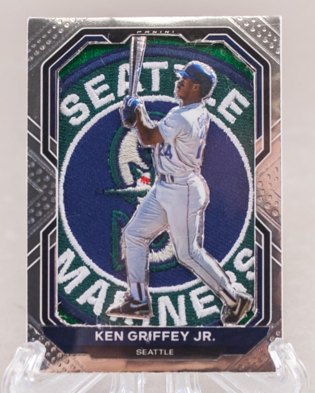 2021 Panini MLB Ken Griffey Jr. Jersey Patch Card: This lot presents a 2021 Panini Prizm Baseball Ken Griffey Jr. jersey patch card. The front of the card features an image of Ken Griffey Jr. in a Seattle Mariners uniform, set against an embroidered t