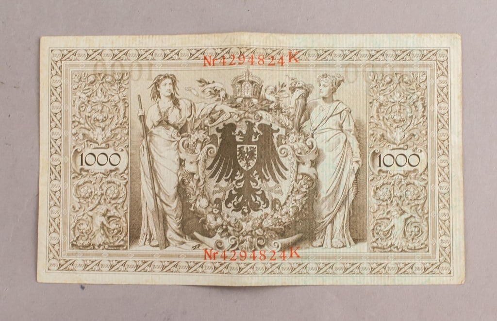 1910 Germany 1000 Mark Banknote: Germany 1000 Mark banknote dated 1910. Issued by the Reichsbankdirektorium, with serial number in red. Obverse features imperial coat of arms flanked by allegorical female figures and denomination “