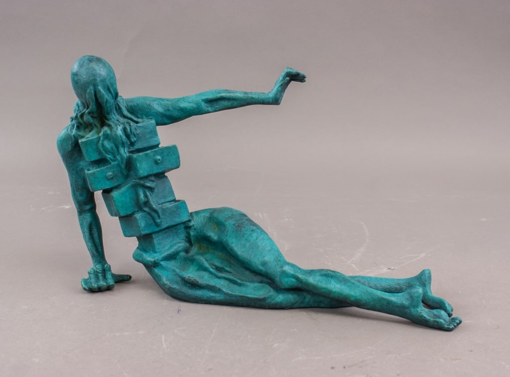 Bronze Sculpture Signed Salvador Dali w/Provenance: Bronze sculpture. Cast in bronze and bearing the artist’s signature, depicting a stylized reclining male figure with geometric elements integrated into the torso; patinated surface in green tones. A