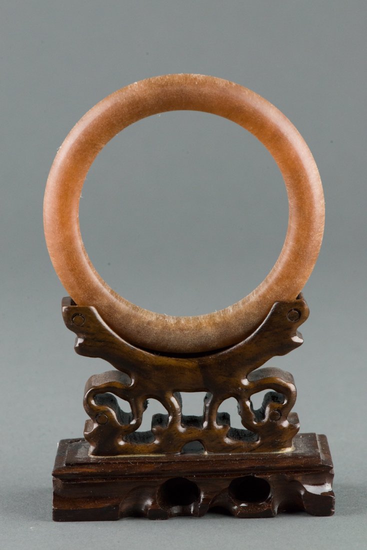 Fine Chinese Horn Carved Circular Bangle: Fine Chinese horn carved bangle, of honey brown tone with rounded edge. Wooden stand not included. D: 8.5 cm, inner D: 6.5 cm, 33 grams. Provenance: T. Ng Collection Toronto.