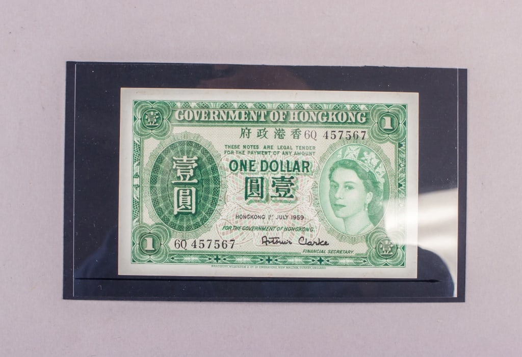 1959 Hong Kong $1 Banknote: A 1959 Hong Kong one-dollar banknote, printed in green with portrait of Queen Elizabeth II at right, bilingual text, serial number, and dated 1 July 1959 with printed signature of the Financial