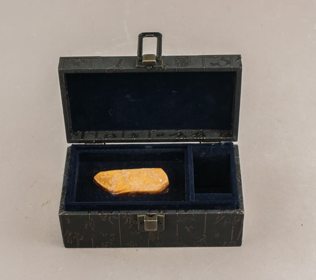 Rare Chinese Shoushan Tianhuang Stone w/ Box: Rare Tianhuang stone carving housed in fitted presentation box. The stone displays a rich amber-yellow hue with natural inclusions. Presented in a black hinged box with metal clasp, lined in deep blue