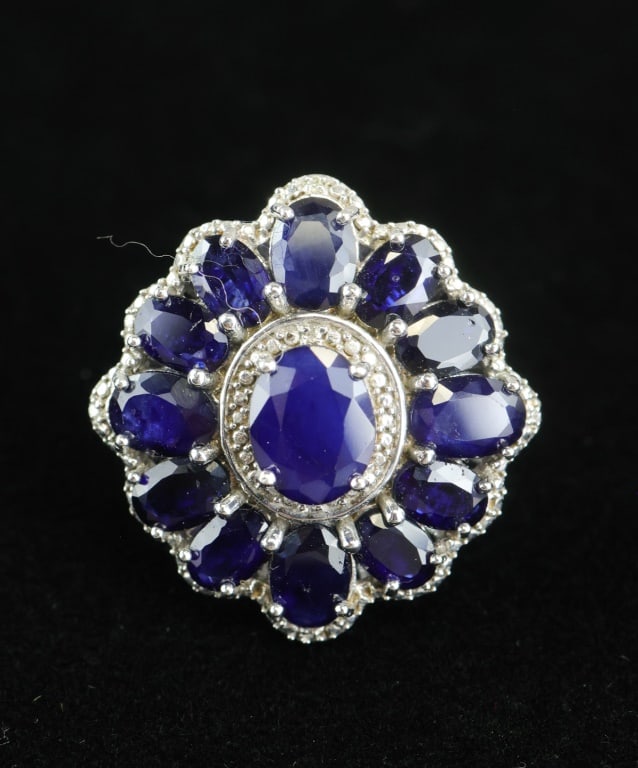 925 Silver 12.20ct Blue Sapphires Ring w/Appraisal: 925 sterling silver ring set with thirteen oval blue sapphires totaling 12.20cts, each moderately included and color- and clarity-enhanced, arranged in a floral cluster within a high-polish mount weig