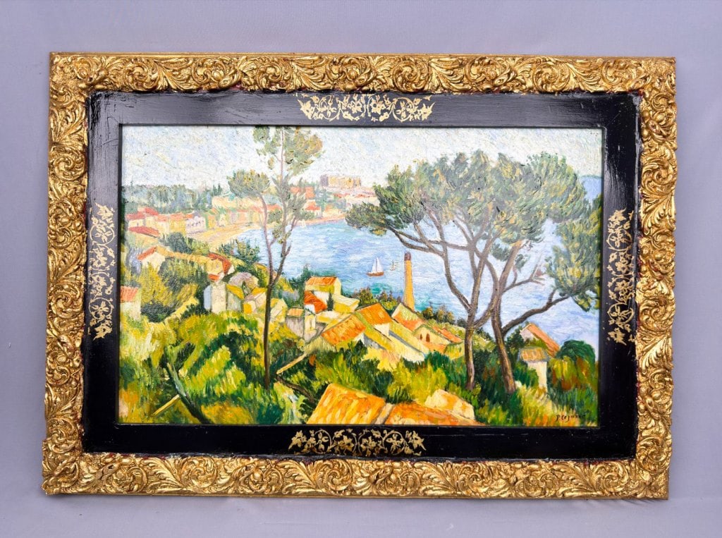 OOC Signed Pablo Cézanne Galerie Charpentier: Oil on canvas, framed. Attributed to Pablo Cézanne (1839–1906). Depicting a coastal landscape with red-tiled rooftops, tall trees, dense greenery, and a view toward open water with a distant sailbo
