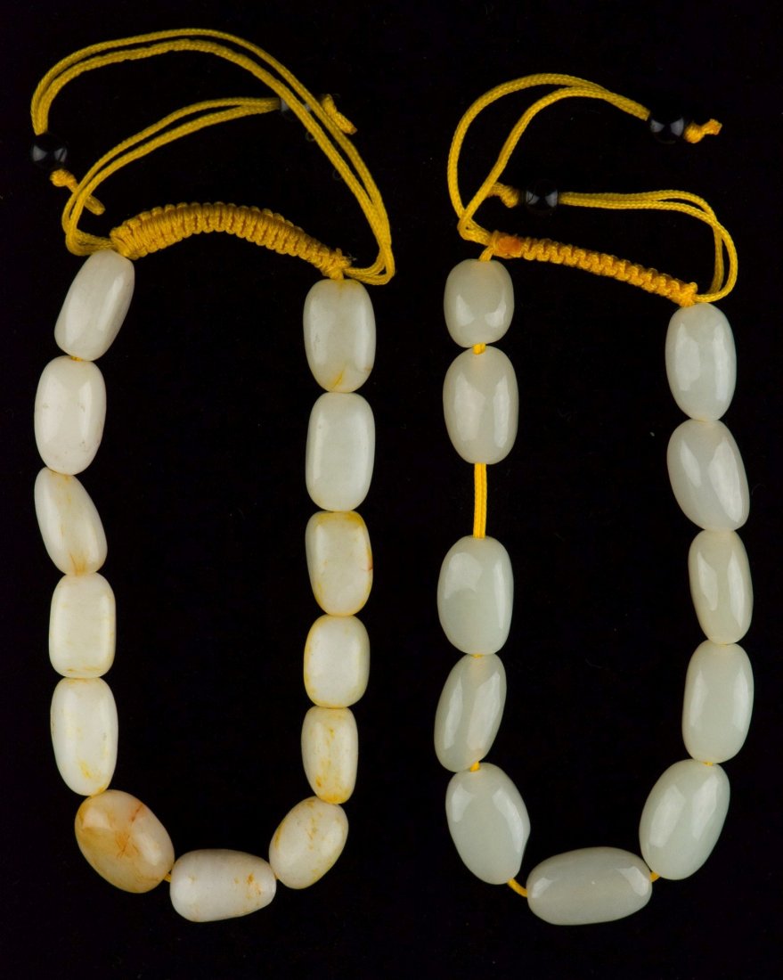 Pair of Chinese White Hardstone Carved Bracelets: Fine pair of Chinese white hardstone carved bead bracelets, composed of eleven and thirteen fine hardstone beads. Bead H: 1.7 cm, W: 0.9 cm, D: 6 cm, 58 grams.