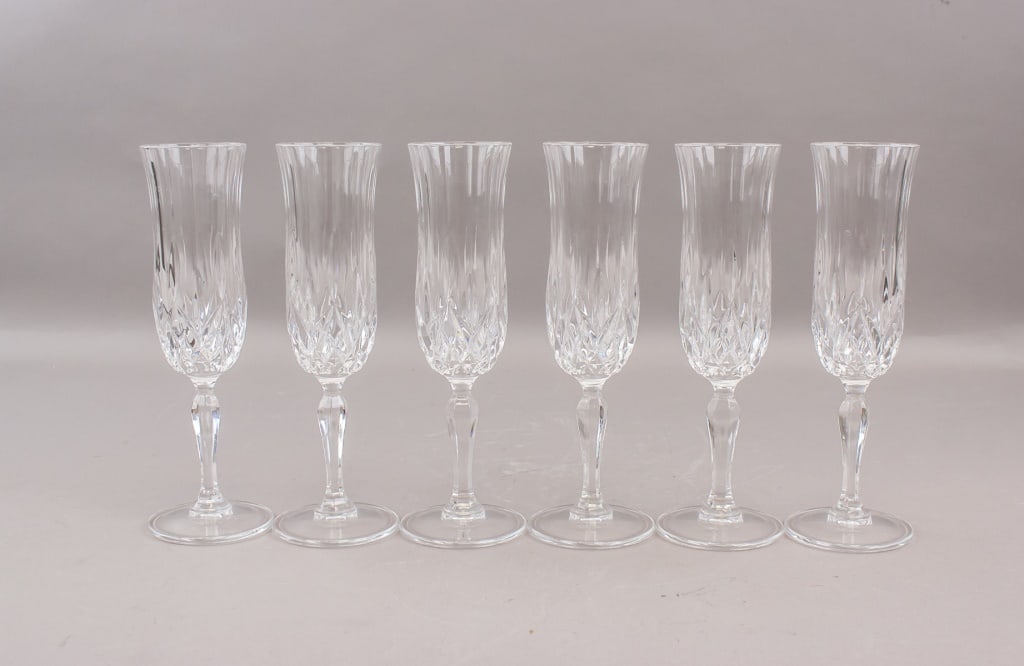 RCR Cristalleria Opera Champagne Flutes 6pc: RCR Cristalleria Opera champagne flutes set of six, each in clear cut crystal with long slender stems and fluted bowls accented by faceted lower panels, the group matching in form and finish and showi
