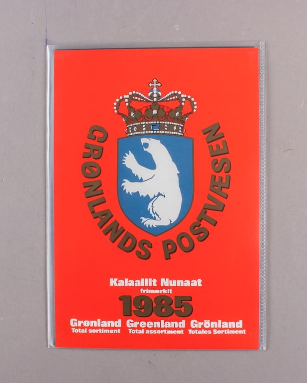 1985 Greenland Official Year Stamps: 1985 Greenland official year stamp set in original red booklet issued by Gr?nlands Postv?sen. Includes nine mint stamps featuring portraits, wildlife, and cultural themes, along with one charity seal 