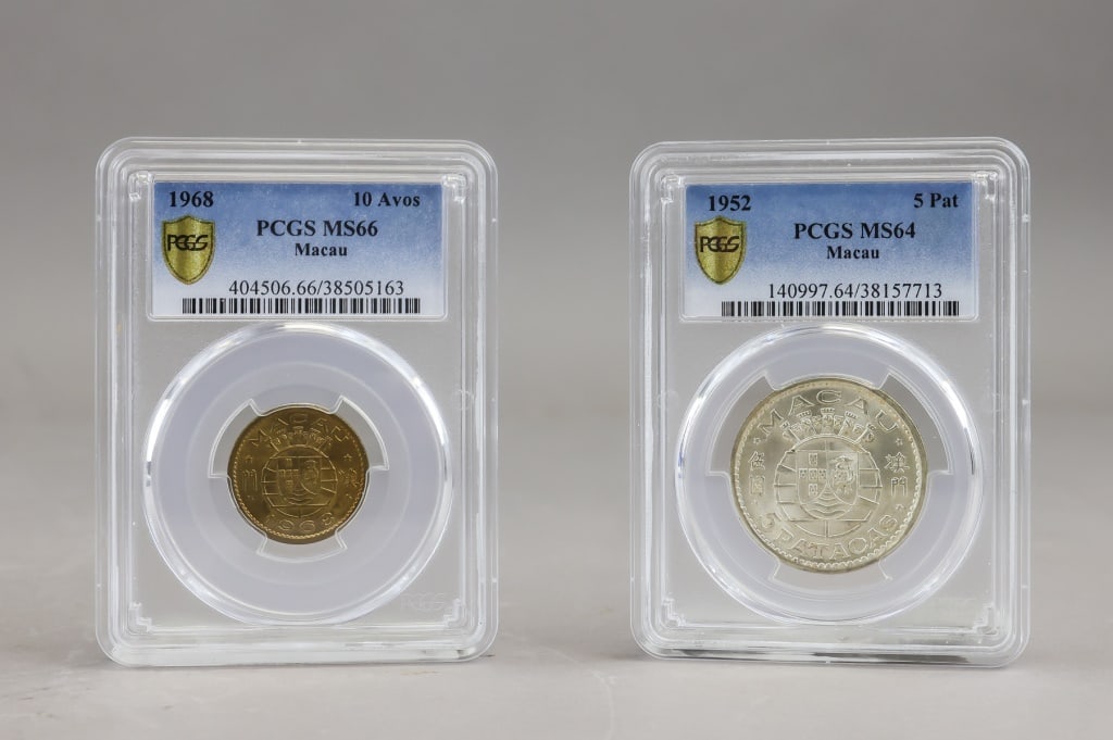 PCGS 1952 & 1968 Macau Coins 2pc: PCGS-certified Macau coin pair comprising a 1968 10?Avos graded MS66 and a 1952 5?Patacas graded MS64, each housed in its respective encapsulated holder with full label details. H: 9 cm, W: 6 cm, 73g.