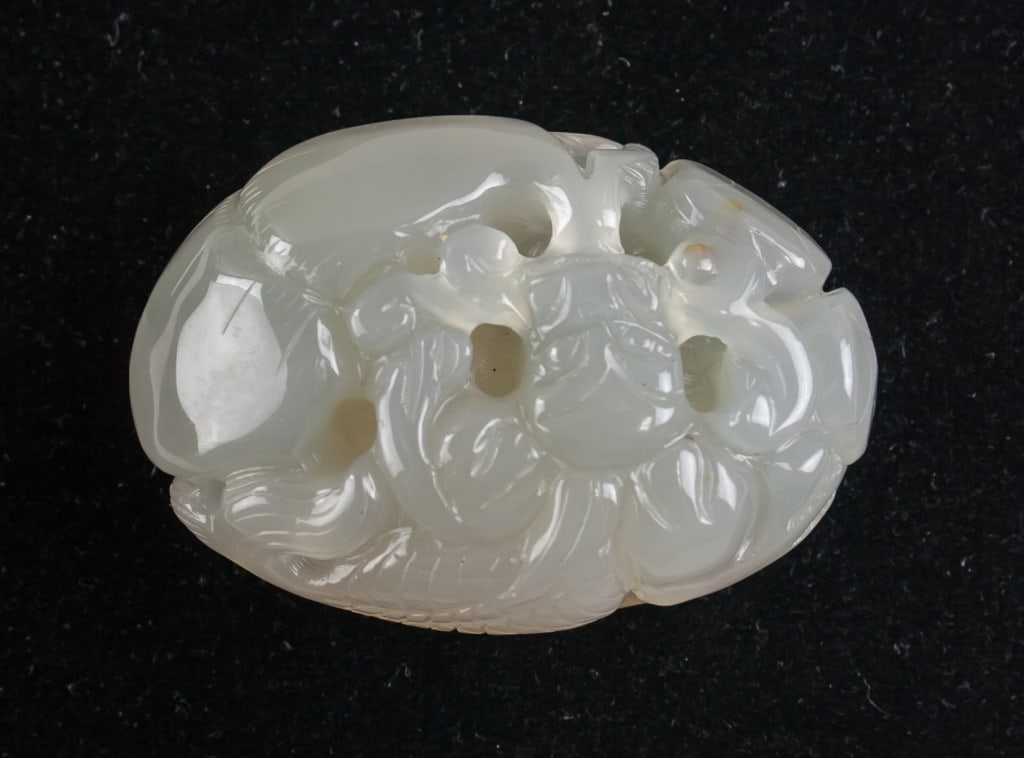 Chinese White Shoushan Stone Carved Pendant: Chinese White Shoushan Stone Carved Pendant. Oval-shaped pendant carved from fine-grained white Shoushan stone, featuring a figural motif in low relief on the front and a recessed area on the reverse 