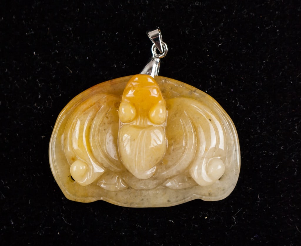 Chinese Yellow Jade Carved Bat Pendant: A finely carved yellow jade pendant featuring a bat motif, symbolizing good fortune and prosperity in Chinese culture. The jade exhibits a warm golden hue with natural variations in tone. The carving 
