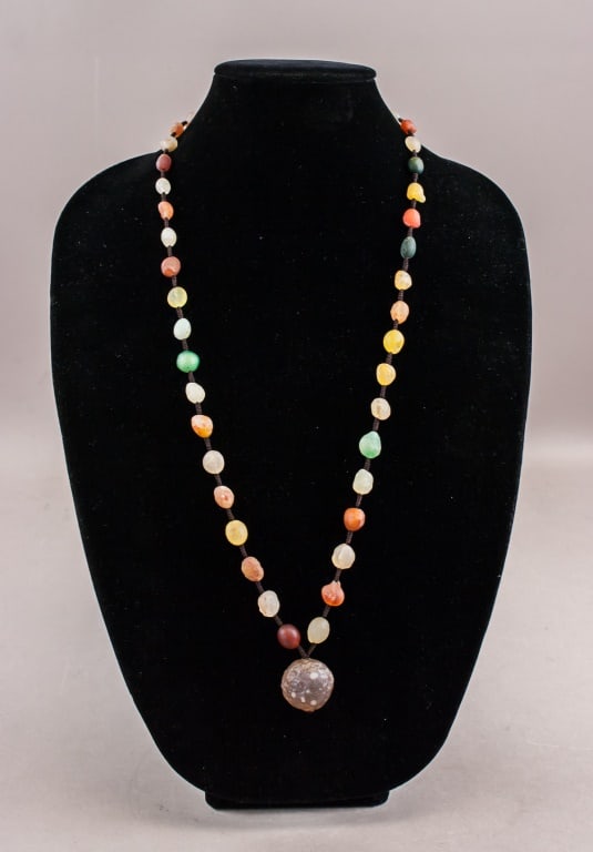 Chinese Natural Amber Beams Necklace: This exquisite piece features a harmonious blend of multi-colored amber beads, ranging from deep cognac to pale yellow, with occasional green tones. Each bead is meticulously selected for its unique