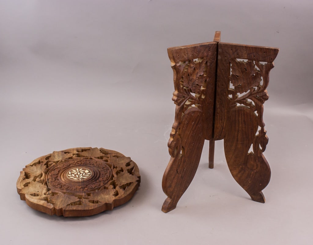 Chinese Hand-carved Wooden Tripod Side Table: Chinese hand-carved wooden tripod side table with circular top featuring carved floral motifs and central inlay, supported by folding carved legs. H: 37 cm, Dia: 28 cm, 1,946g