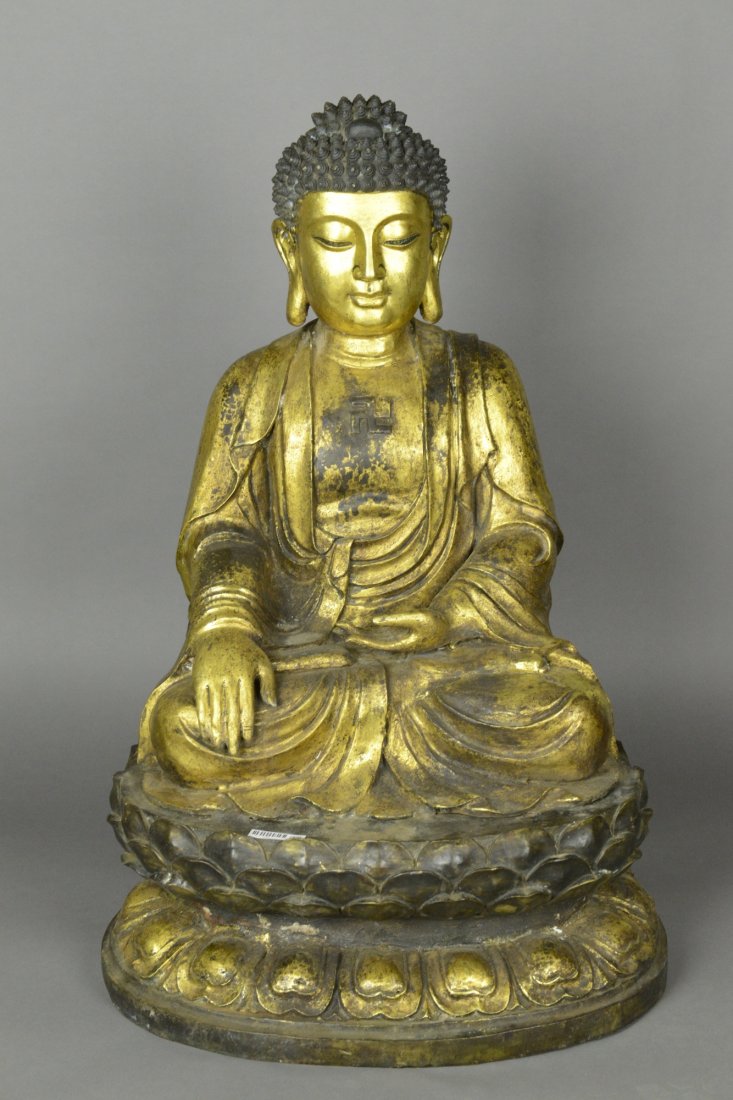 Large Bronze Gilt Buddha on Lotus 18th/19thC: With downcast eyes and serene expressions, the bronze Buddha is seated cross legged on double lotus plinth. Chest incised Buddhist symbol. 18th - 19th century. H: 72 cm, W: 43 cm.