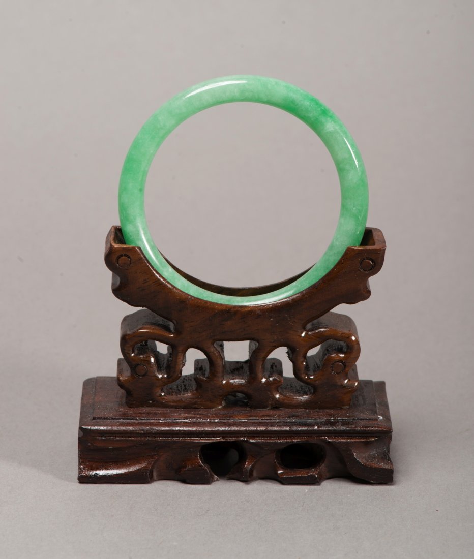 Chinese Apple Green Jadeite Bangle: Chinese circular jadeite bangle, of opaque apple green tone, rounded edge. Wooden stand not included. D: 7 cm, inner D: 5.5 cm, 32 grams.