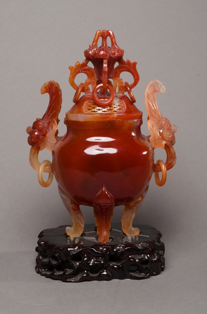 Exceptional Chinese Agate Censer with Loose Rings: The fine carved agate censer is in globular form with two archaic faces as handles, topped with large open works finial with loose rings, supported on four foot, resting on wood carved rockery stand. 
