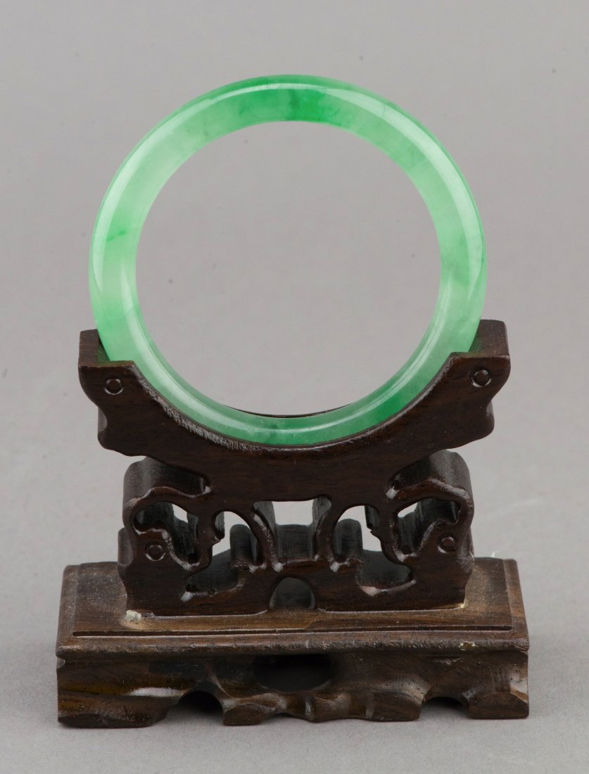 Natural Chinese Emerald Green Jadeite Bangle: Natural Chinese emerald green jadeite bangle, rounded edge with excellent translucency, wooden stand not included. D: 7 cm, inner D: 5.5 cm, 41 grams.