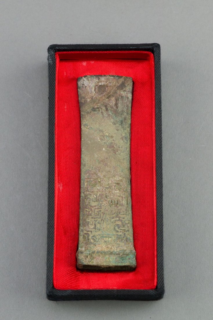 Chinese Archaistic Bronze Axe Head: Chinese archaistic bronze axe head with tapering body and hollowed end. Preserved inside . H: 10.5 cm, W: 3 cm, 152 grams. Ma Collection Toronto