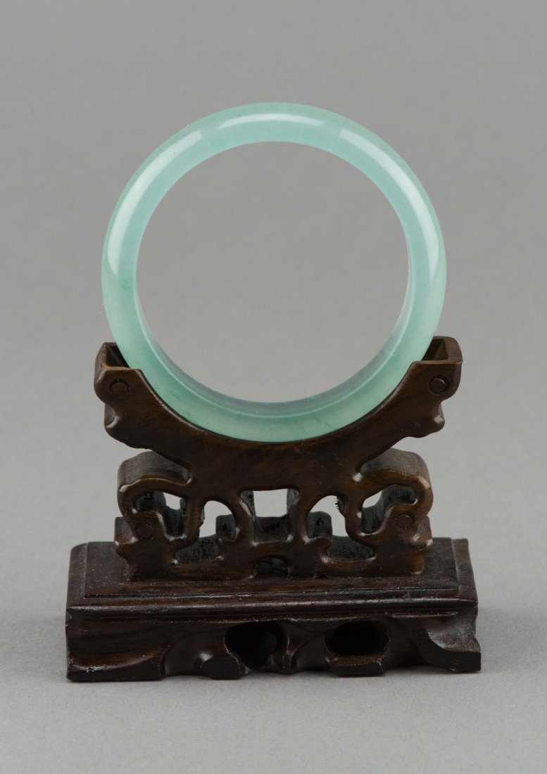 Chinese Translucent Green Jadeite Bangle: Charming Chinese jadeite carved bangle, semi-rounded edge, with excellent translucency. Wooden stand not included. D: 7.5 cm, inner D: 5.5 cm, 43 grams.
