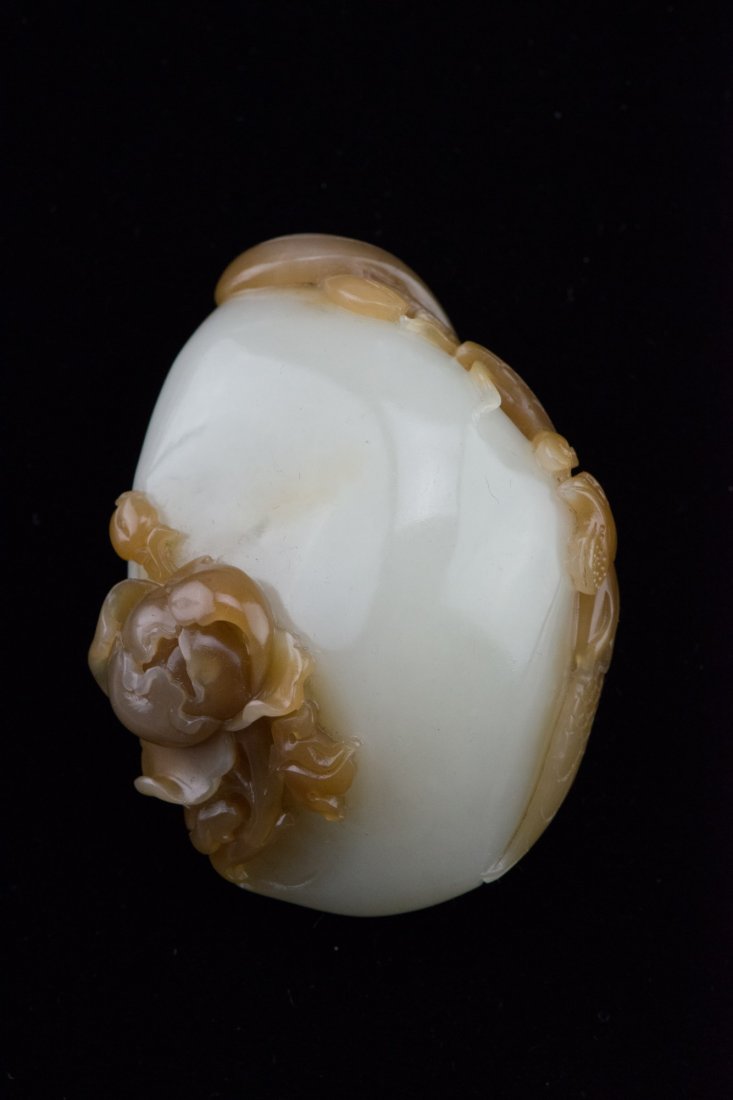 Fine Chinese Hetian White Jade Fish Pebble: Delicately carved from an irregular-shaped pebble on one side with lively carp swimming freely in a pond, the reverse with a lotus flower, dark russet color incorporated into design; 7.8 cm x 6.7 cm,