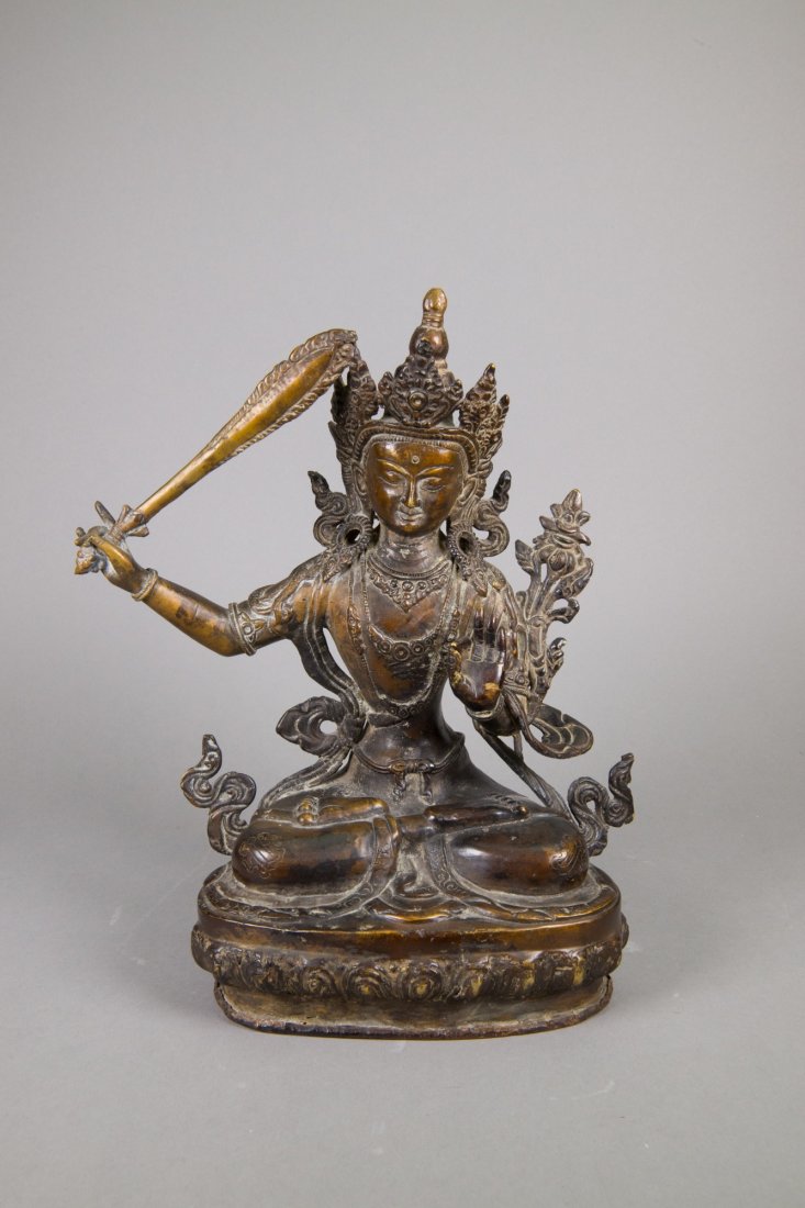Chinese Bronze Seated Figure of Manjushri: 文殊菩萨青铜坐像 Chinese bronze figure of Manjushri; seated cross-legged atop a double lotus plinth and holding a flaming sword in his right hand; H: 33