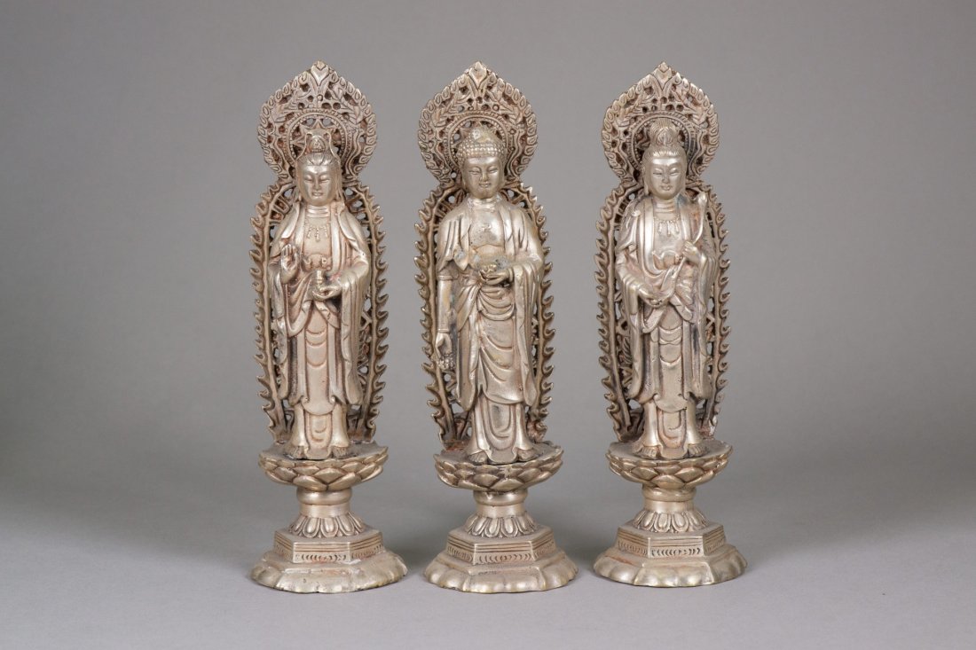 Set of Three Chinese Silver Guanyin Figures: 银观音像 三件 Two Chinese Guanyin and one Buddha statue standing on lotus plinth with carved flaming aureole; one Guanyin holding a ruyi and the other one holding a