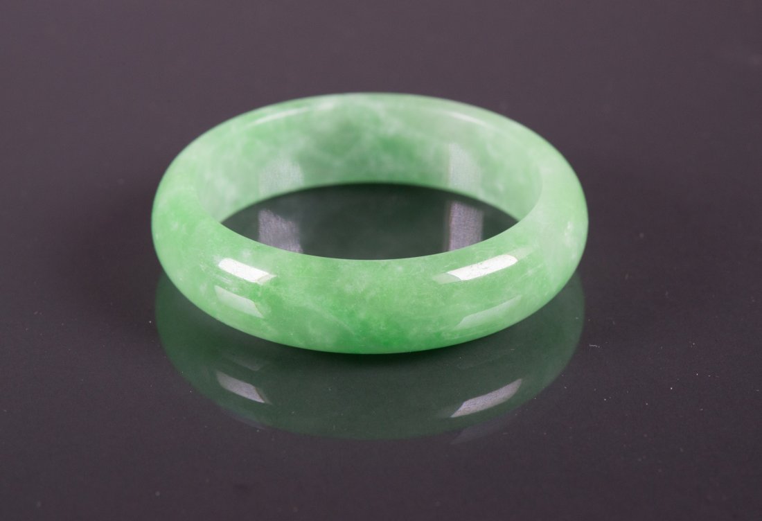 Chinese Green Jadeite Carved Bangle: Chinese green jadeite bangle; featuring rounded edge outside and flatten edge inside; of apple green tone; D: 7 cm, Inner D: 5.5 cm, 60 grams, Density: 3.30