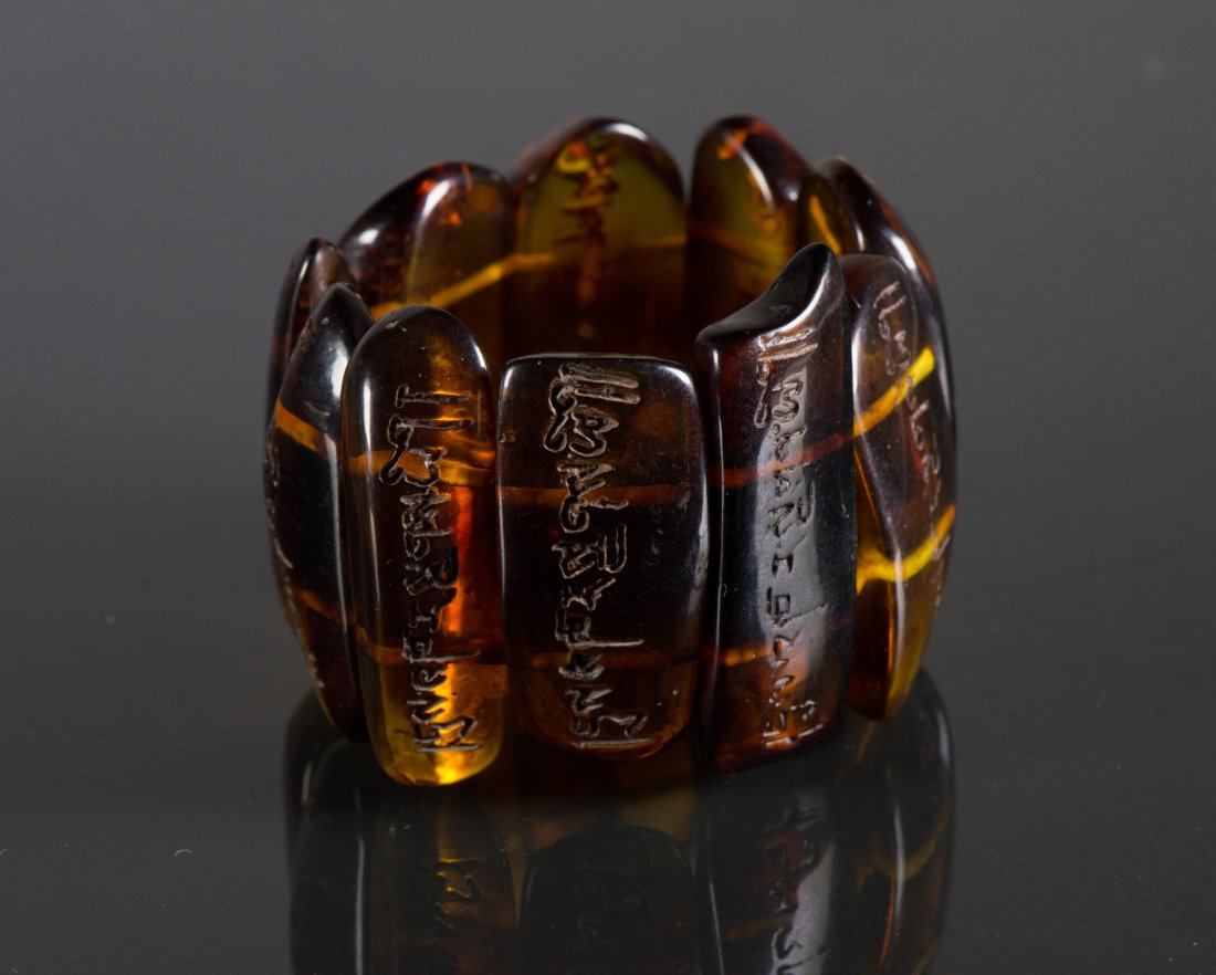 Chinese Dark Amber w/ Letters Bracelet: Chinese dark amber bracelet; comprised of strip beads with ancient Chinese character carvings; of dark brown tone; H: 5.5 cm, W: 2.5 cm (bead), D: 8 cm, 105 grams