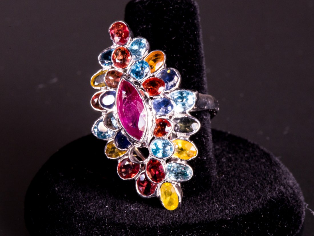 Sterling Silver Sapphire & Ruby Ring CRV$800: On ladies large marquise shape multi-coloured sapphire and ruby cluster style ring; stamped 925 sterling silver; insurance replacement value $800; 7.8 grams