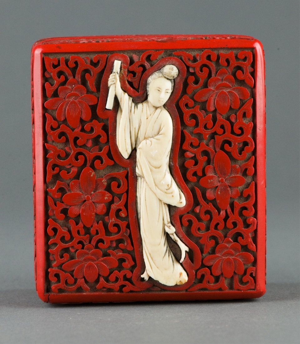 Chinese Lacquer Box w Ivory Inlaid Figure: Fine Chinese red lacquer box inlaid with ivory carved lady, of square shaped box heavily decorated with lotus and sprigs, inlaid with ivory carved lady in robes holding a scroll. H: 4 cm, L: 9 cm, 218